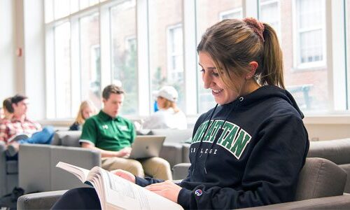 Manhattan College student reading a book.