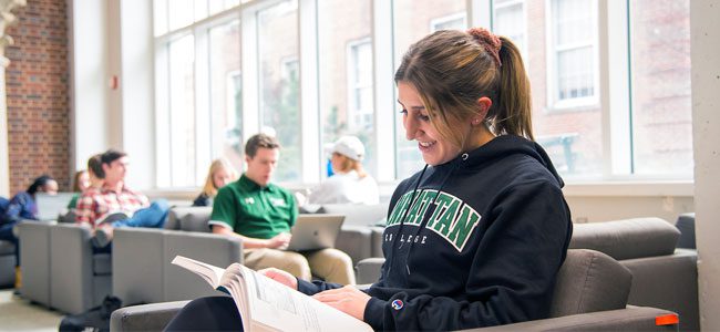 Manhattan College student reading a book.