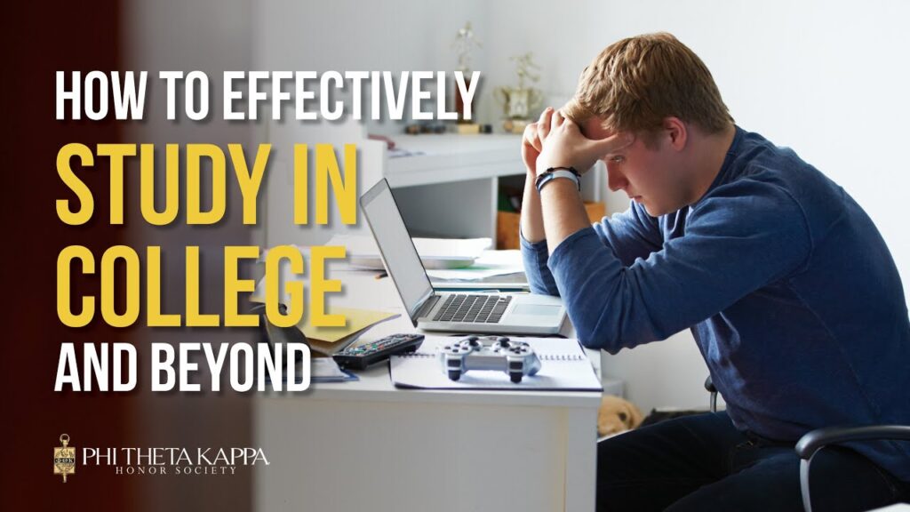 Student sitting at desk in front of laptop with head in his hands.