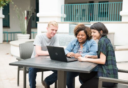 students viewing laptop